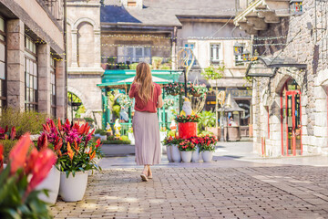 Fototapeta premium Young woman tourist walks down the street in a European city after the end of COVID-19 coronavirus. quarantine is over