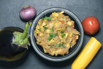 Mashed Brinjal recipe with healthy veggetable served in a Bowl.It's a popular recipe in India.