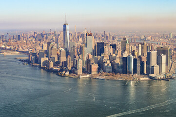 The city skyline of New York City in USA, United States on a cloudy, blue sky day with iconic buildings  from aerial, point of view. 