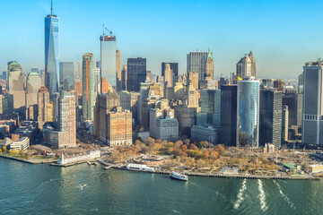 Fototapeta premium The city skyline of New York City in USA, United States on a cloudy, blue sky day with iconic buildings from aerial, point of view. 