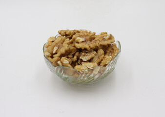 Bowl with tasty walnuts isolated on white background