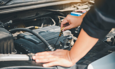 maintenance technician is doing a preliminary inspection of the engine to be ready to use. Concept of car maintenance