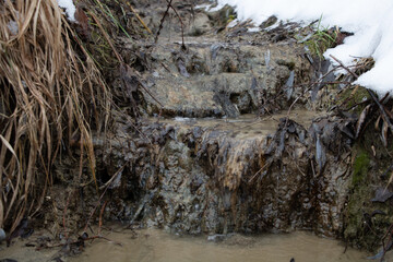 A very small river flows slowly in nature. winter time