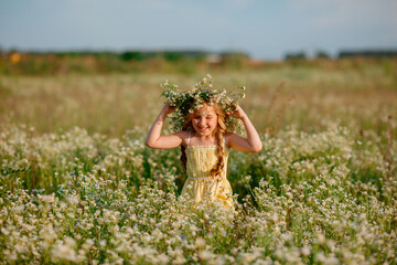 little girl in the field with a wreath on her head walking summer
