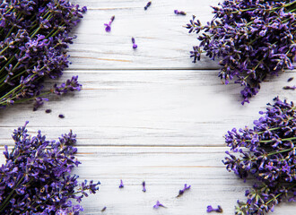 Fresh flowers of lavender bouquet, top view on white wooden background