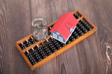 Count the dollar coins in glass bottles on the beads and the model of the small house