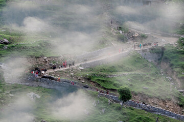 aerial  landscape with smoke and fog over green meadows 