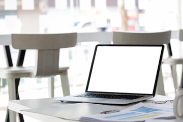Laptop computer with mockup or blank screen on white desk in workspace and copy space concept