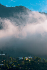 landscapes of beautiful Kashmir, vertical landscape with wooden  huts and cloudy  mountains , kel...