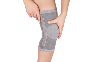 Knee Support Brace on leg isolated on white background. Orthopedic Anatomic Orthosis. Braces for...
