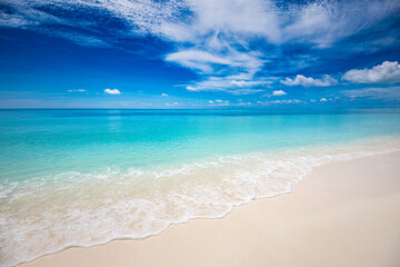 Fototapeta na wymiar Closeup of sand on beach and blue summer sky. Panoramic beach landscape. Empty tropical beach and seascape. Blue sky, soft sand, calmness, tranquil relaxing sunlight, summer mood. Travel vacation