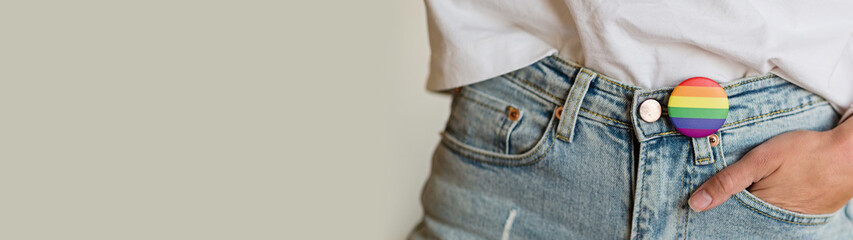Stylish Woman in blue jeans with the LGBT pride flag sign. Concept of the Pride day, Valentine day,...