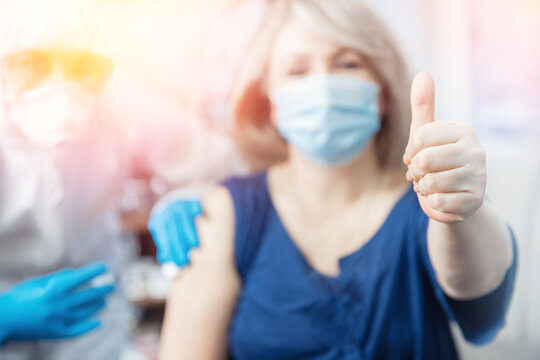 Concept vaccination Covid-19 or coronavirus of senior people in houses, doctor visits home. Nurse giving injection vaccine to elderly woman clinic