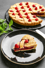 Piece of delicious raspberry pie on plate