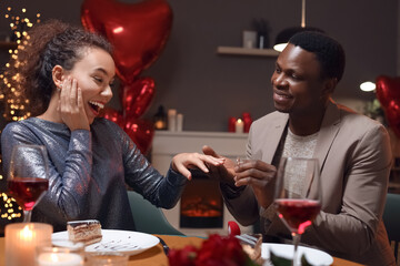 African-American man proposing to his beloved on Valentine's Day at home