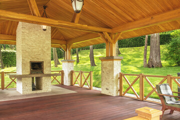 Fragment of a gazebo by the lake and a beautiful fireplace for grilling. of a gazebo by the lake...