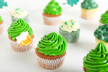 Tasty cupcakes for St. Patrick's Day on white background