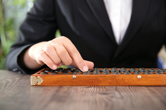 Female accountant using traditional Chinese abacus