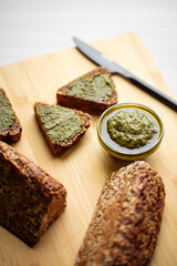 Side view on sliced triangle flourless diet grain bread on parchment paper