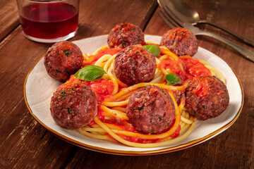Meatballs with pasta, Italian dinner on a dark rustic wooden background