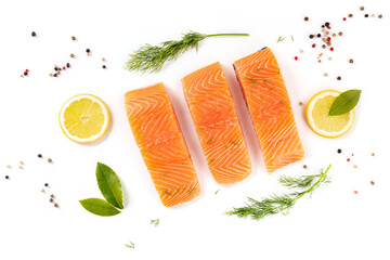 Raw salmon, shot from above with herbs and spices on a white background