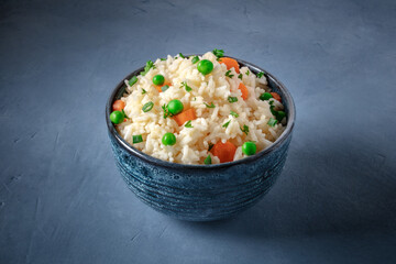 Rice with vegetables on a dark blue background, easy recipe