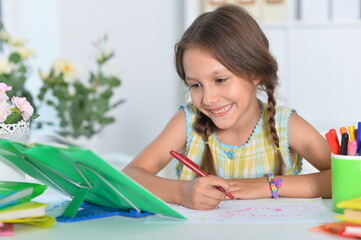 Cute little girl studying  at home