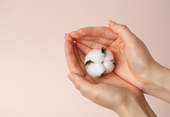 The hand of the woman holding the white cotton ball.