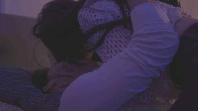 a young guy enjoys watching his girlfriend seduce him