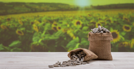 Sunflower seeds in linen bag, Sunflower seeds farm in the background,. Sunflower seeds on the table