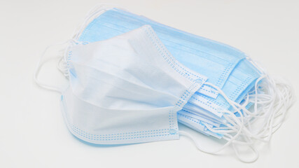 Protective disposable respiratory medical face masks close up on white background.