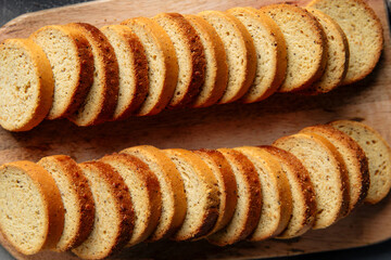 Top view on dried bread croutons on the wooden cutting board
