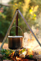cooking on a campfire in a cauldron on a hike