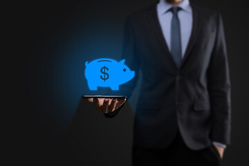 Businessman hold piggy bank icon .Business and Money spending planning, and investment budget, Business saving money concept.save or investment