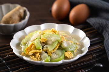 Taiwanese homemade local food of scrambled eggs with loofah gourd and sesame oil.