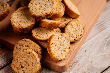 Closeup on pile of dried bread crackers on the wooden background