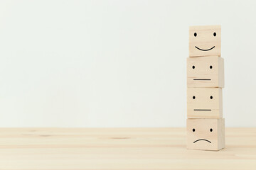 Concept image of satisfaction level. wooden cubes with emotions