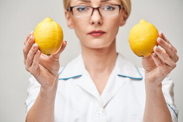 nutritionist doctor healthy lifestyle concept - holding organic lemon fruit