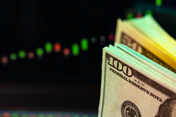 American dollar banknotes and graph on black background