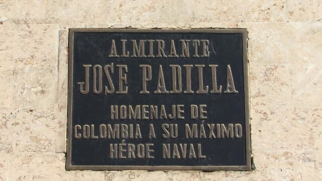 Commemorative plaque of the statue of Admiral Jose Padilla in front of the white colonial building in Cartagena, Colombia.