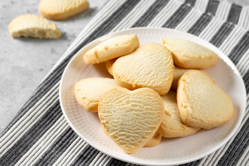 Lemon cookies. Lemon Heart cookies in a white plate on the light gray kitchen table. Cookies for Valentine's Day