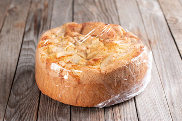 Wrapping sponge cake in plastic for storing