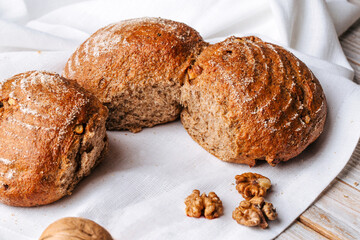 Closeup on rye walnut bread on the wooden decorated table