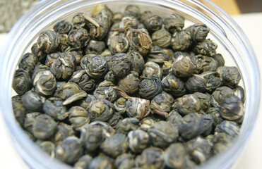 Dried Japanese green tea leaves in a jar