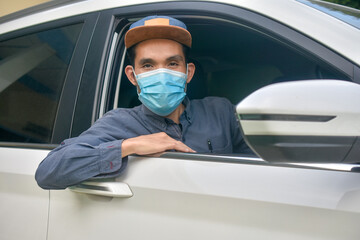 Fototapeta na wymiar Asian man wear medical mask sitting in car to protect coronavirus covid19 ,Mask prevent PM2.5