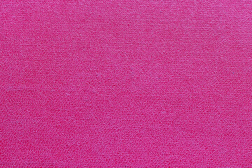 The surface of the red old worn dermatin with a small pattern.