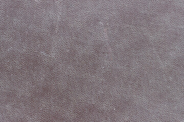 The surface of the brown old worn dermatin with a small pattern.