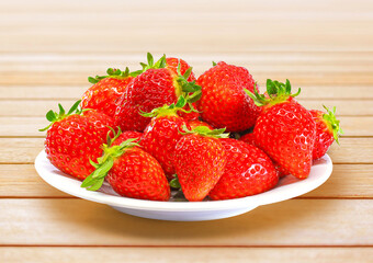 白いお皿に山盛りの完熟いちご 木目背景 1136