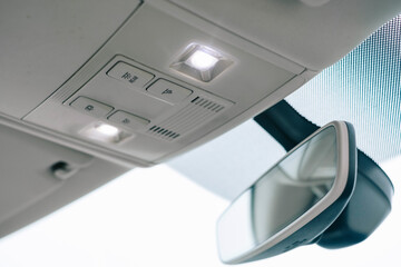 Modern car interior, rear-view mirror with dimming function, LED interior lighting.