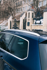 Modern business class car, blue, with chrome parts on the body and LED headlights.